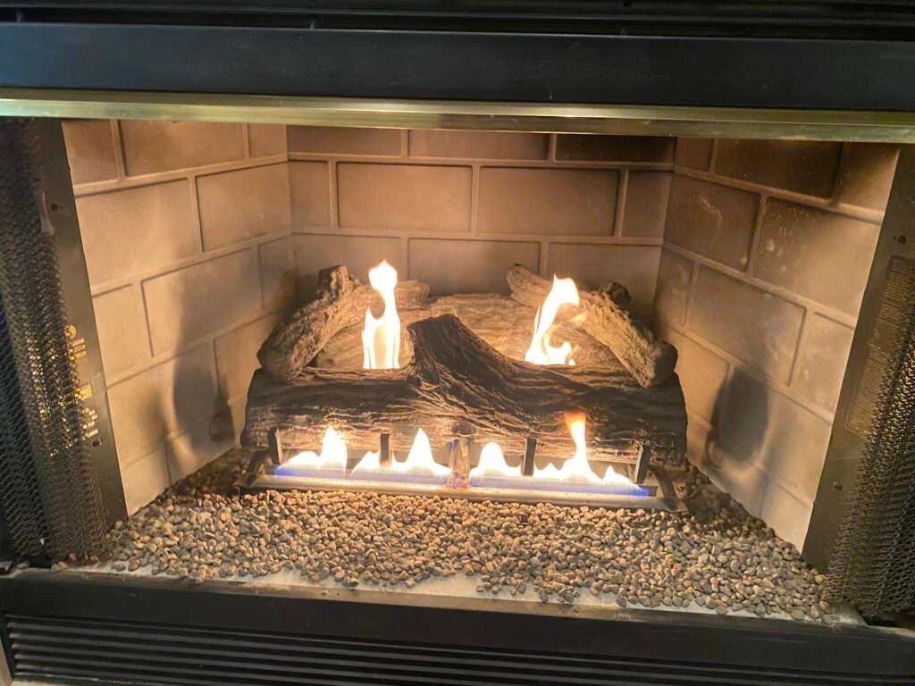Running gas fireplace showing properly operating flame during service