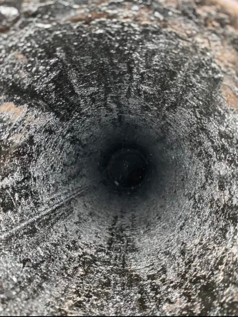 Heavy creosote buildup inside a prefabricated chimney flue