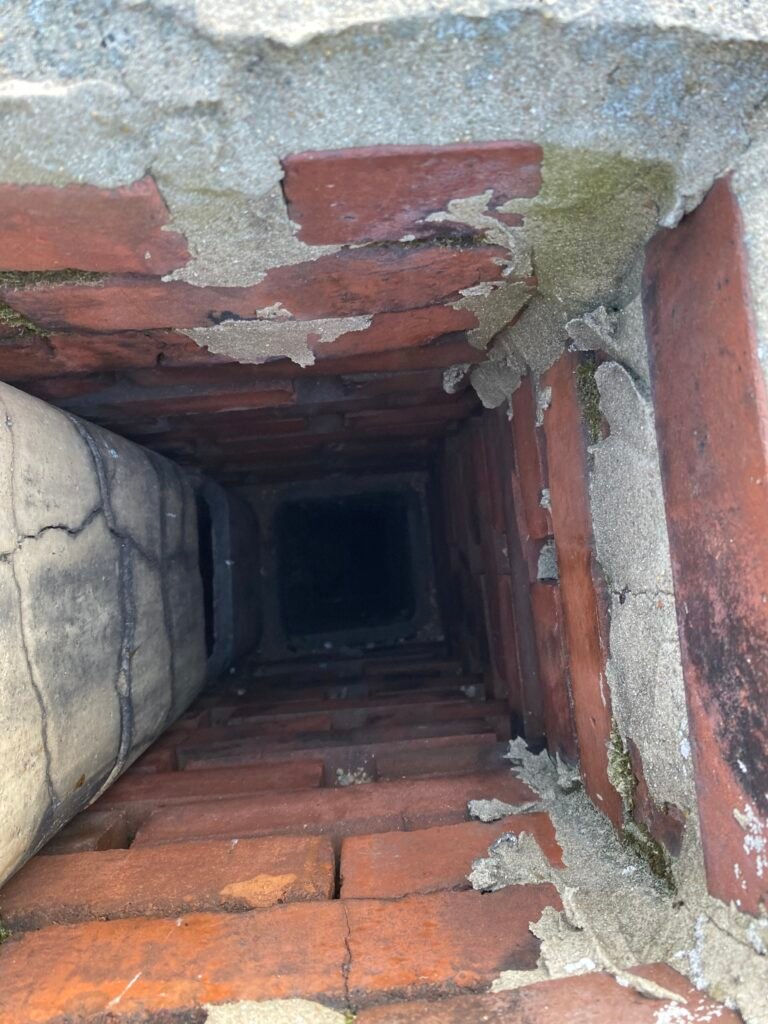 Camera inspection looking down a brick chimney flue