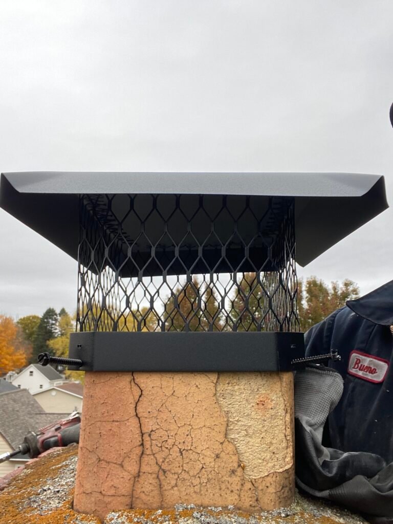Chimney cap being installed on residential chimney