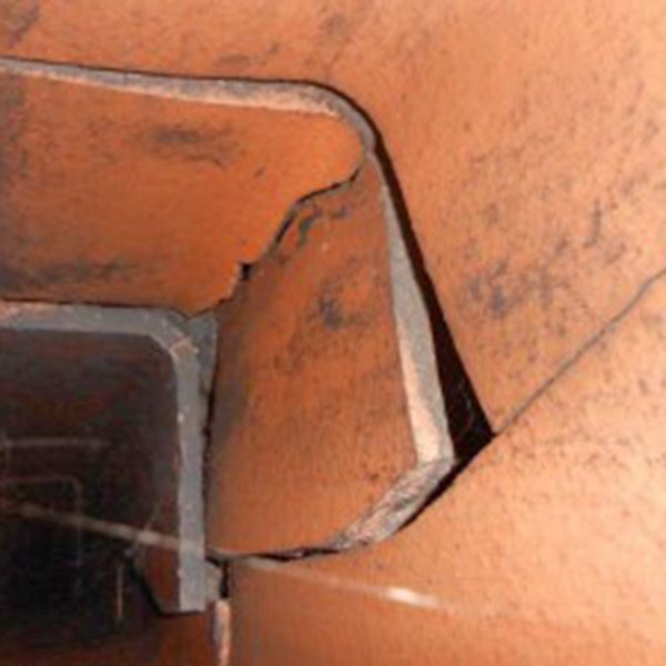 Damaged clay chimney flue with visible cracks