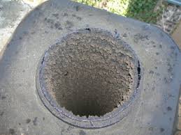 Dirty chimney flue before cleaning with thick soot buildup in Indiana home